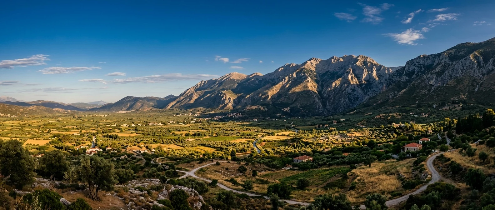 The dramatic mountains of Lakonia and the Spartan plain at golden hour with distant ruins