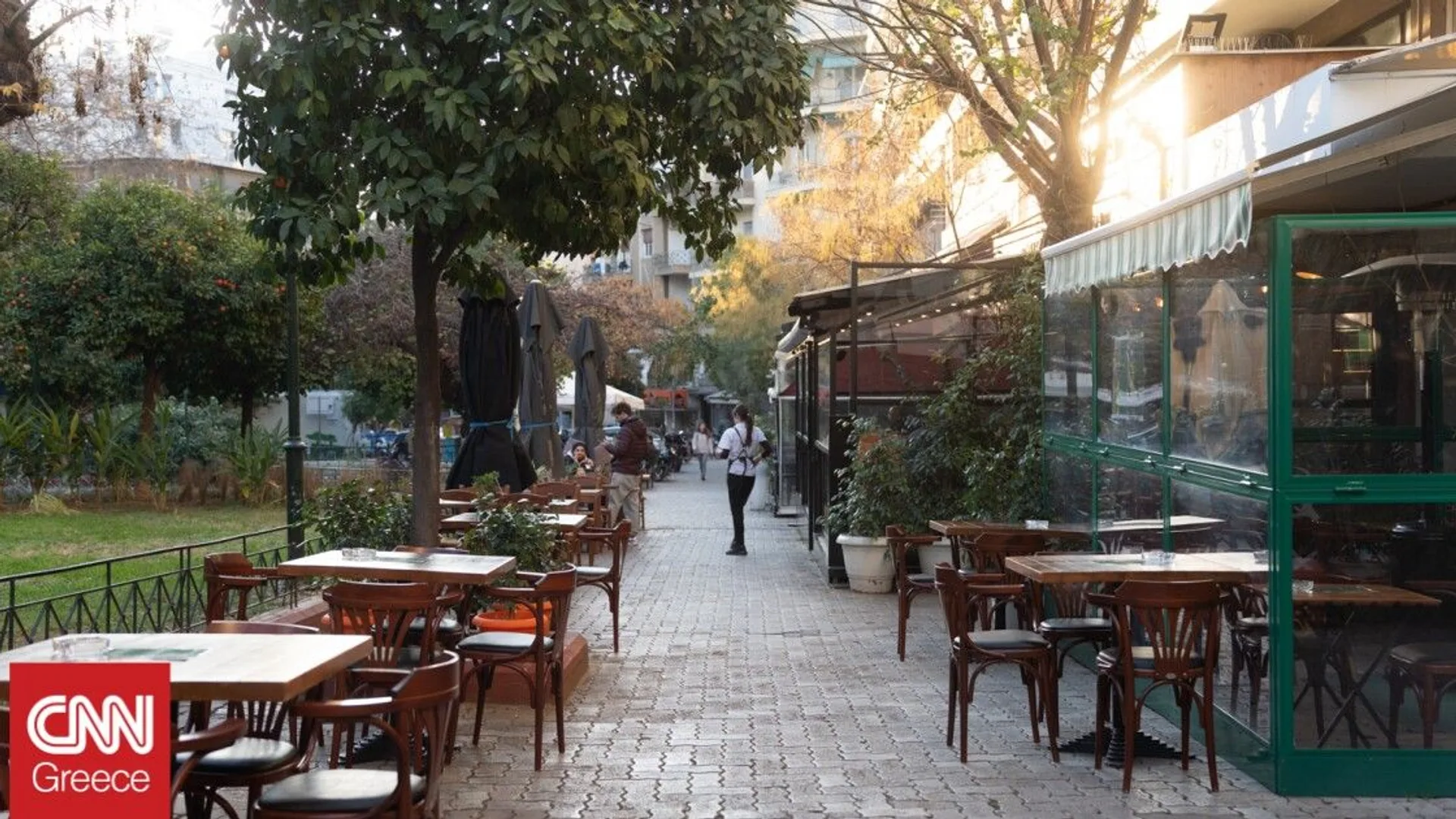 The Fokíonos Négri pedestrian boulevard in Kypséli at golden hour with plane trees