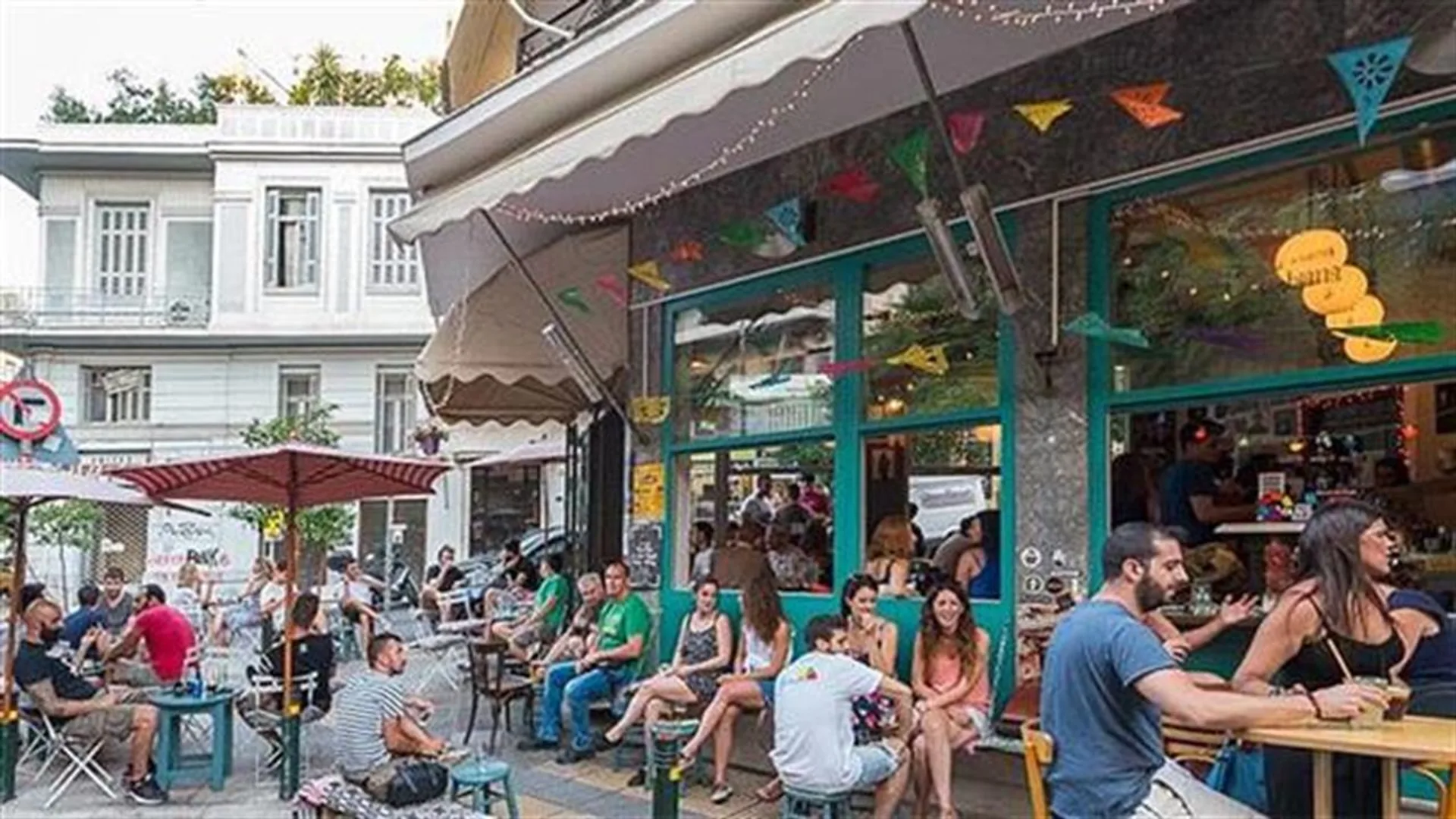 A leafy Pangráti street with a busy local taverna and plane-tree shade
