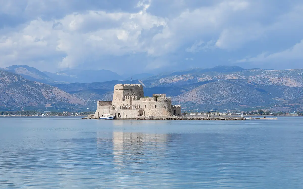 The Bourtzi castle in the sea off Nafplio with mountains in the background