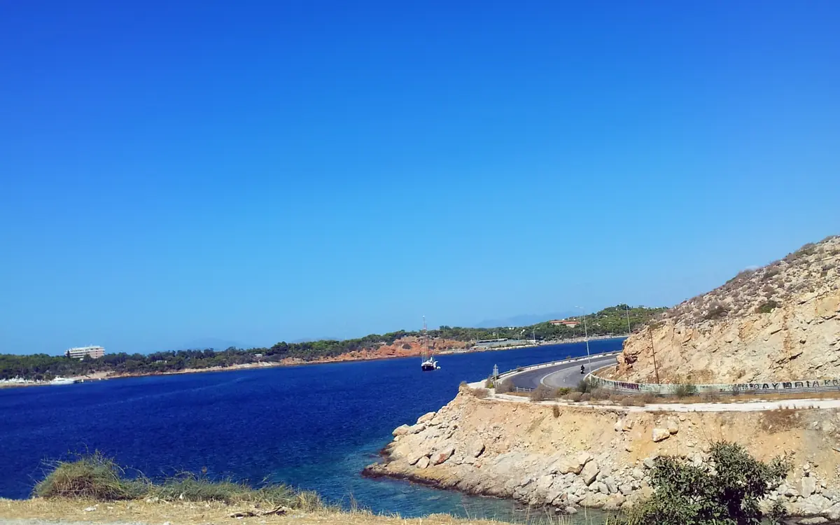 The coastal road to Sounio with blue sea and rocky shoreline