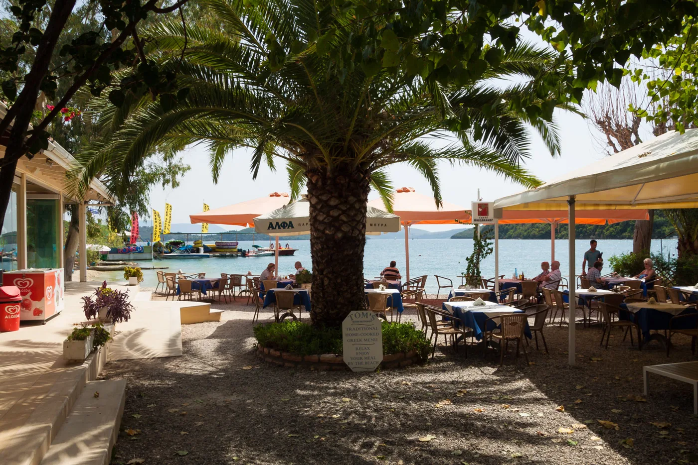 Des tavernes sous un palmier sur le front de mer de Nydri