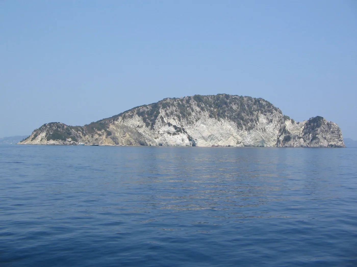 Marathonisi from the sea, a green islet in the Bay of Laganas
