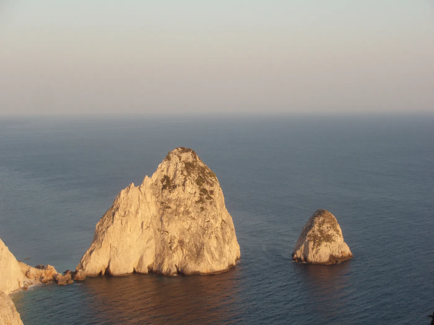 The Mizithres at sunset, golden above a calm sea