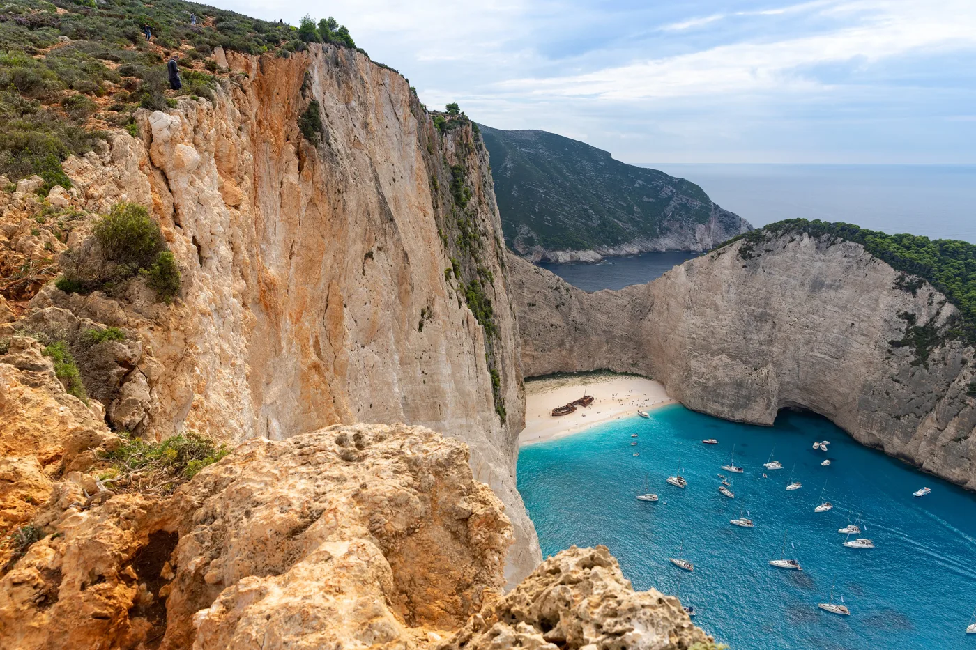 The high cliff above the Navagio cove, with the boats looking tiny below