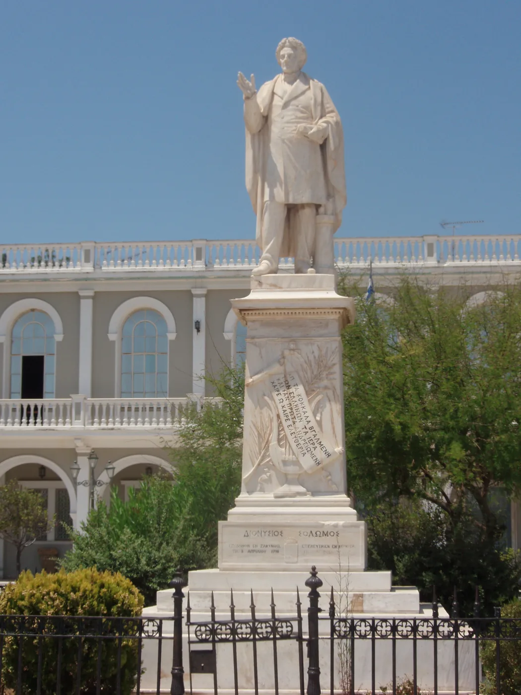 The marble statue of Dionysios Solomos in the square, with the arcade behind