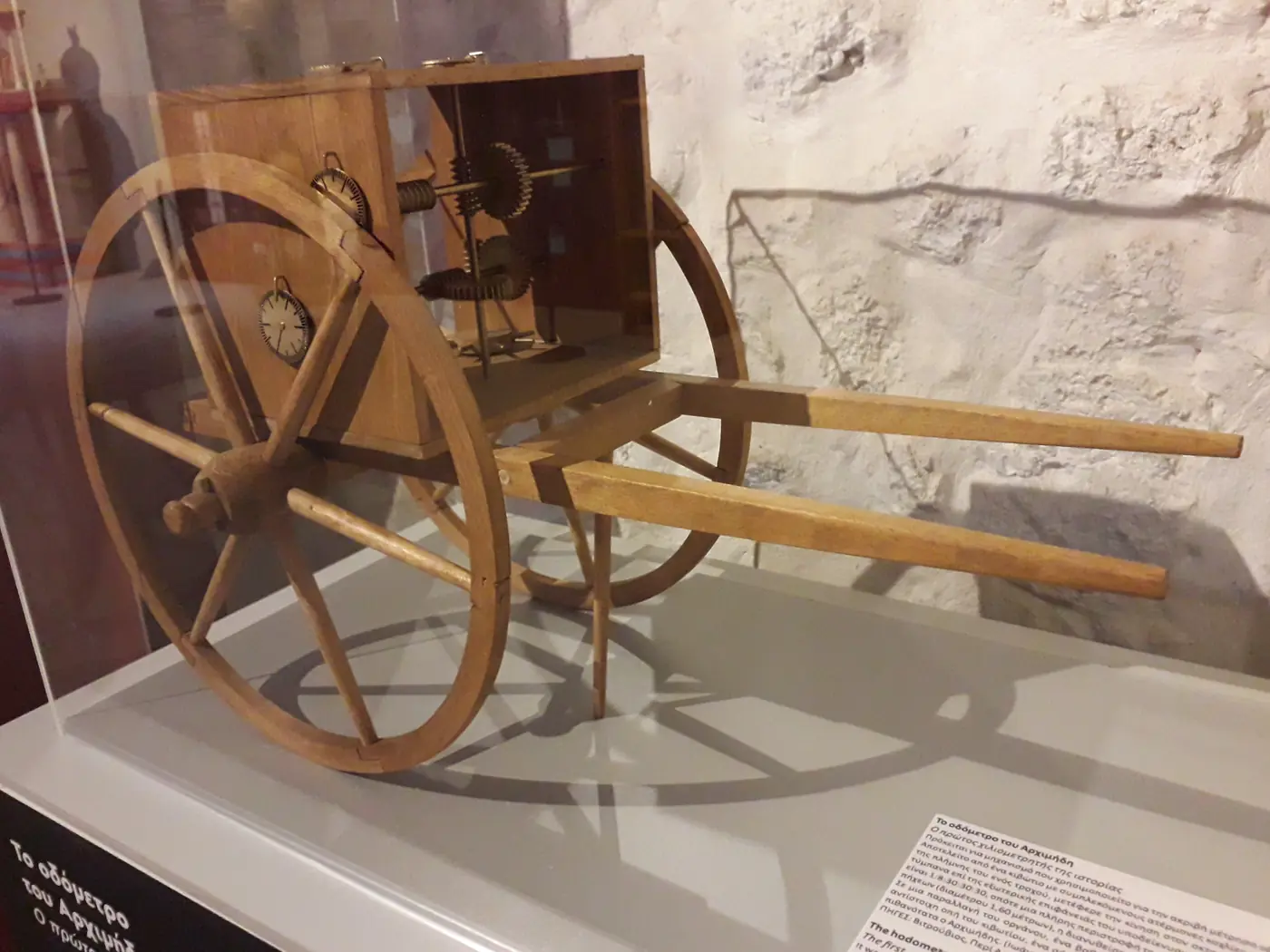 Un antico odometro in legno a forma di carretto con ingranaggi, ricostruito al Museo della tecnologia greca antica